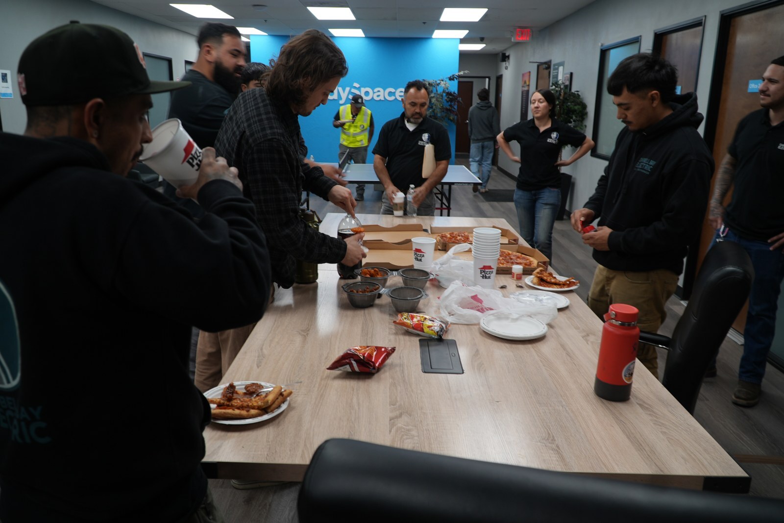 Participants gathered around a table during an EDU visit to Campbell Bay Electric